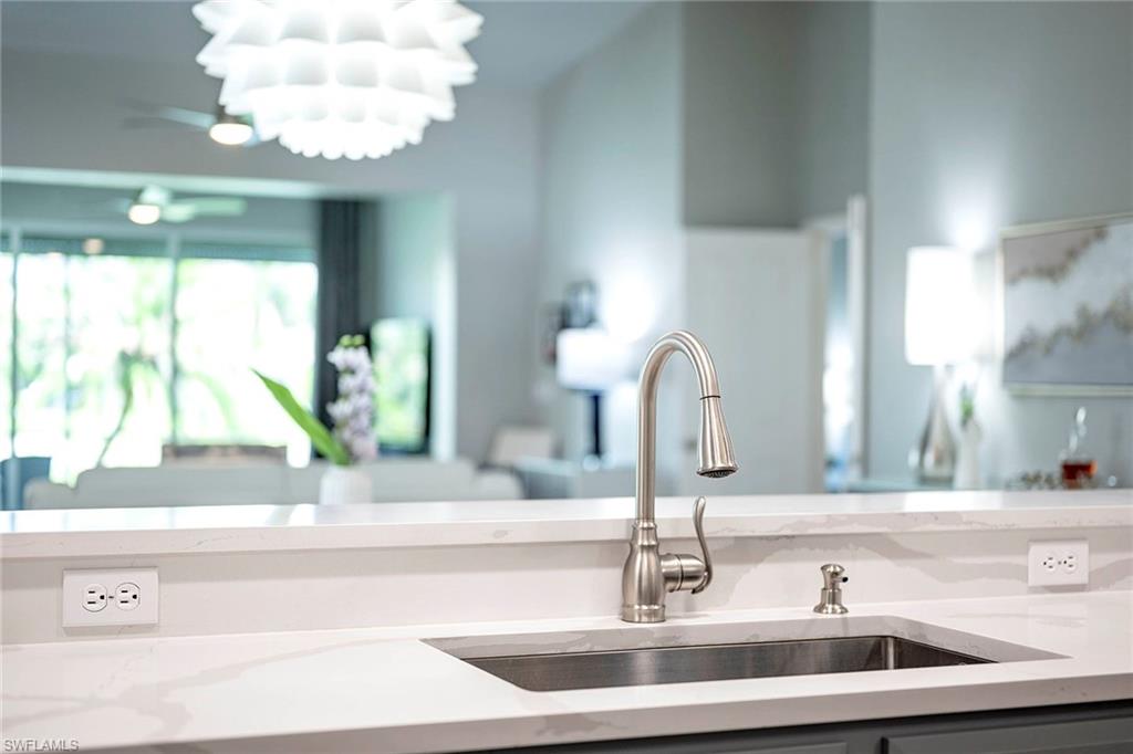 6533 Ilex Circle Naples, FL 34109 - Photo 8 of 34 a bathroom with a sink and a mirror