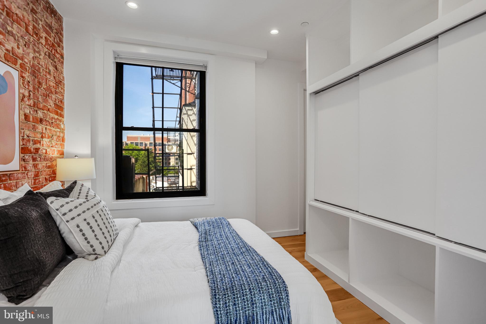 1412 15th Street Northwest, Unit 8 Washington, DC 20005 - Photo 11 of 15 a bedroom with a bed and a window