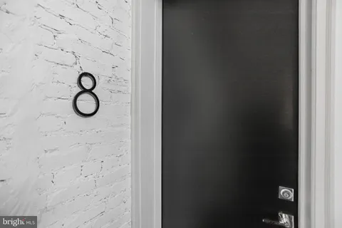 a bathroom with a granite countertop mirror and vanity