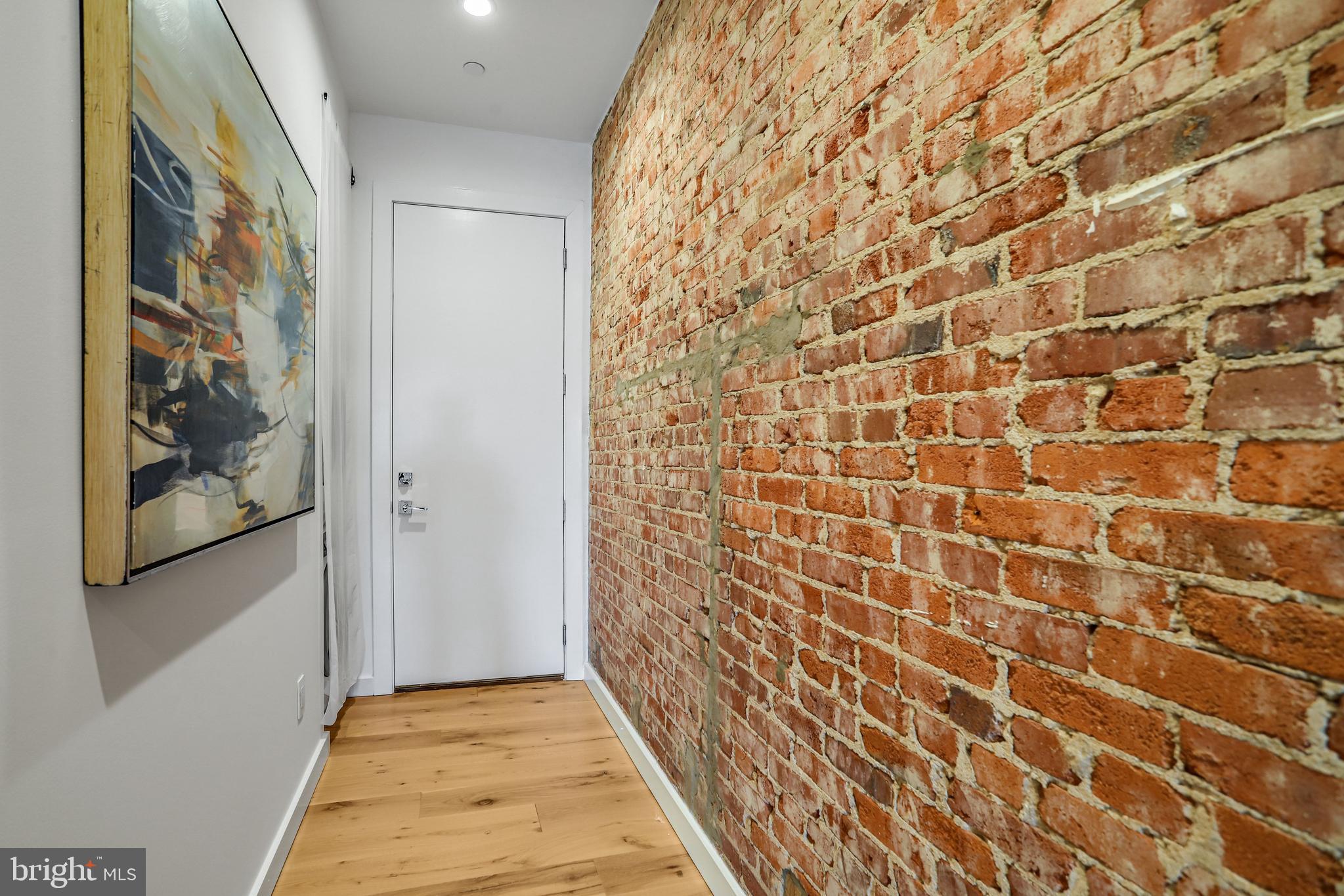 1412 15th Street Northwest, Unit 8 Washington, DC 20005 - Photo 5 of 16 Entry hall with exposed brick wall