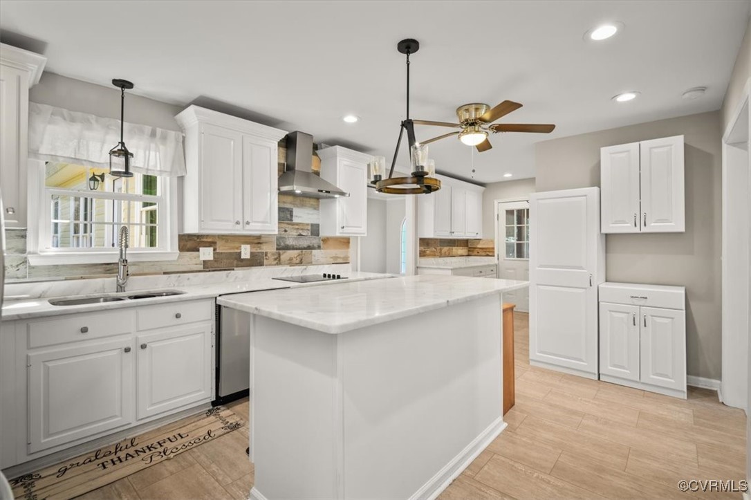 a kitchen with white cabinets and sink