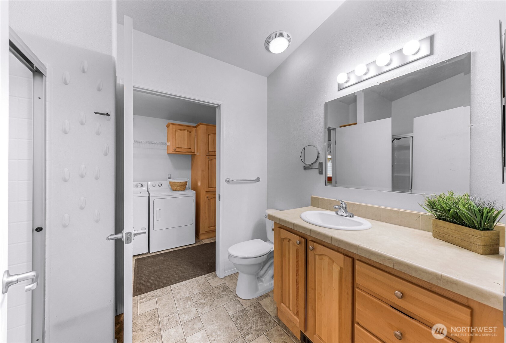6350 Portal Way, Unit 48 Ferndale, WA 98248 - Photo 19 of 37 a spacious bathroom with a granite countertop sink a toilet a mirror and shower