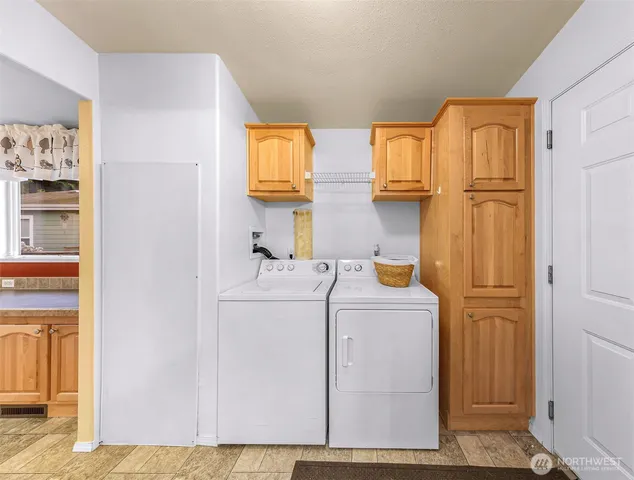 a utility room with closet dryer and washer