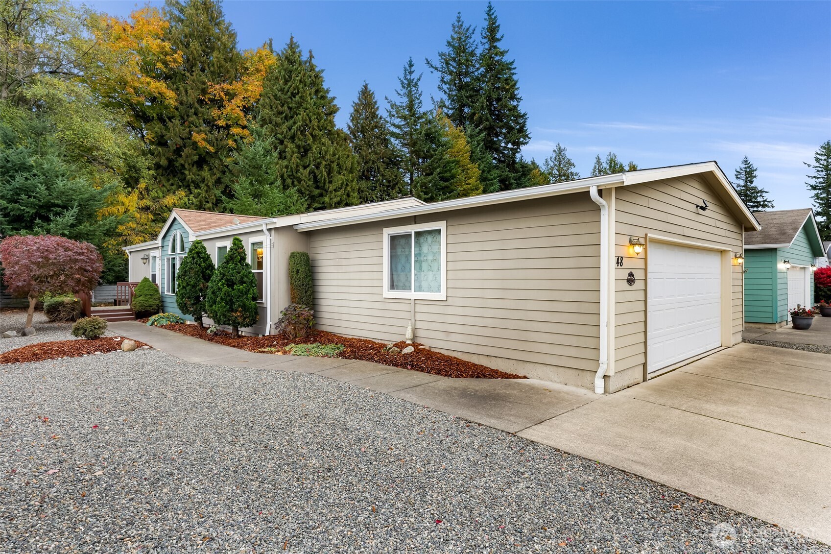 6350 Portal Way, Unit 48 Ferndale, WA 98248 - Photo 2 of 37 a view of a house with backyard and sitting area