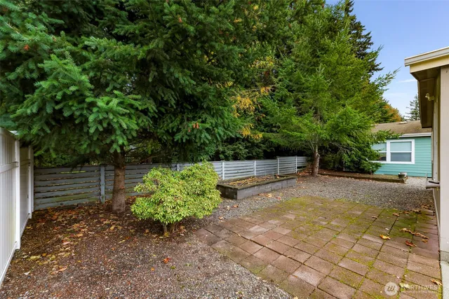 a backyard of a house with yard and outdoor seating