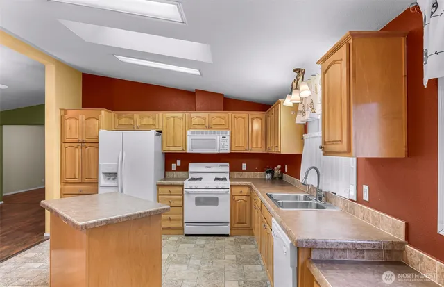 a kitchen with a sink a stove and a refrigerator