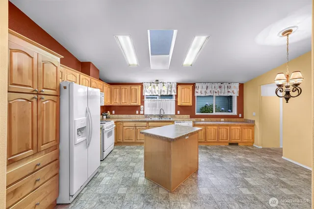 a kitchen with refrigerator and window