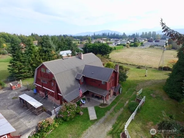 an aerial view of a house with outdoor space and lake view