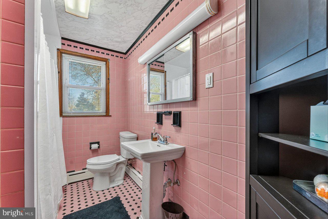 2062 Kinter Avenue Hamilton, NJ 08610 - Photo 12 of 19 a bathroom with a sink a toilet and shower
