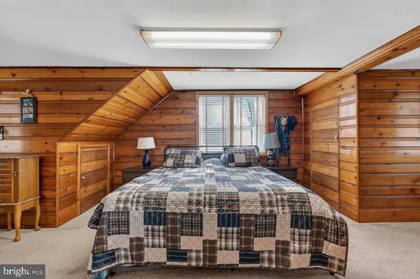 a bedroom with bed and a large window