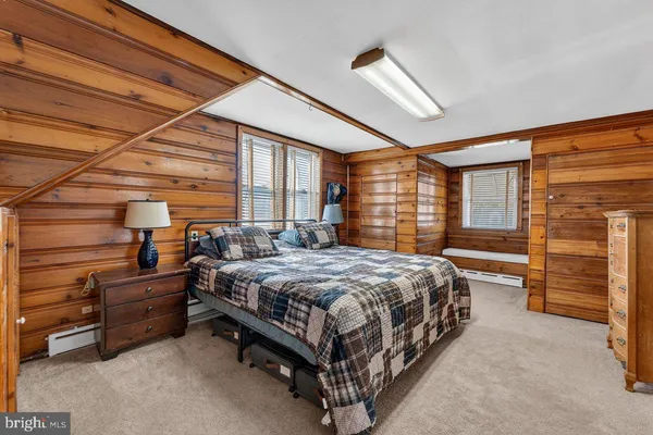 a bed sitting in a room next to a window