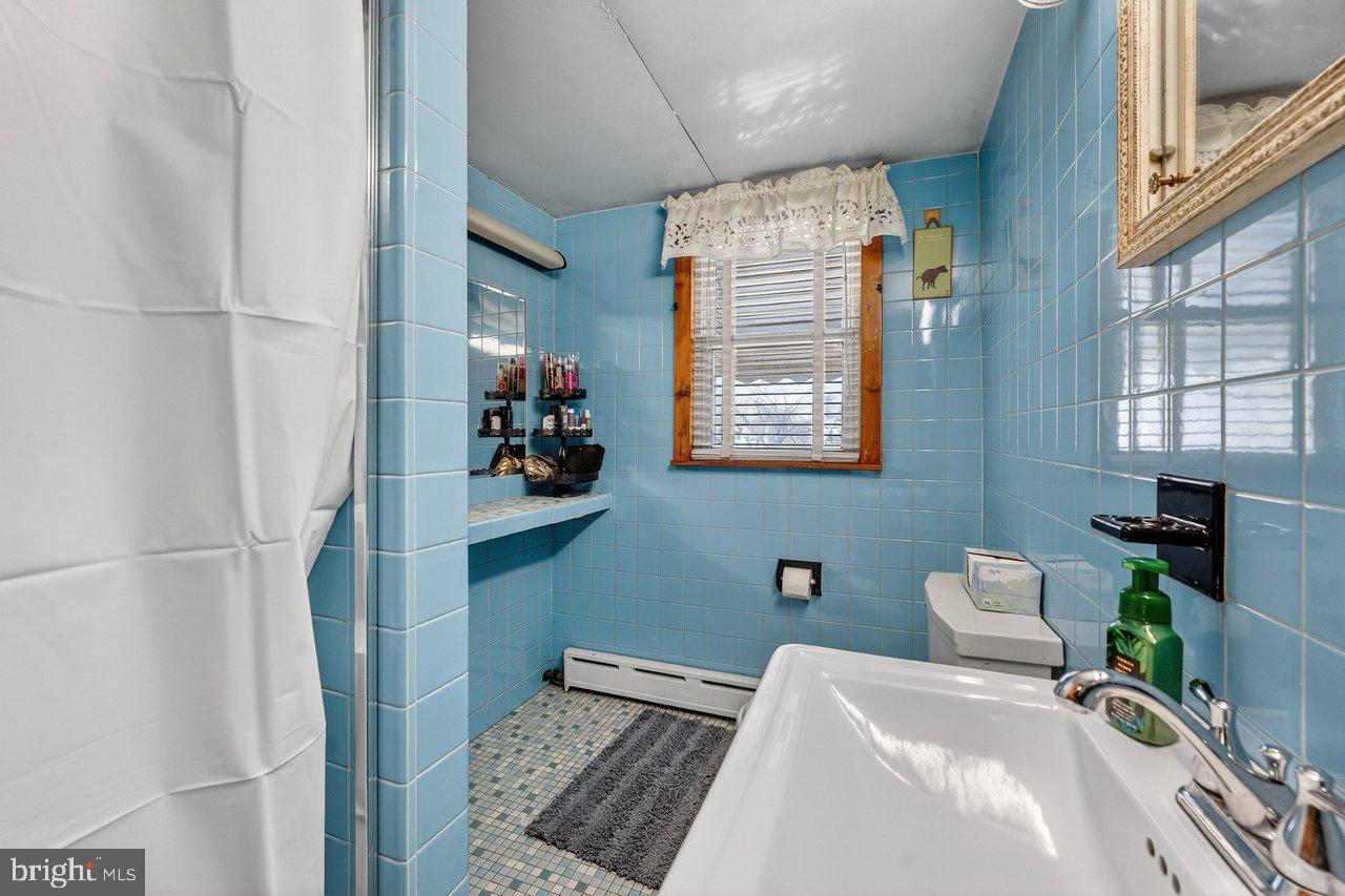 2062 Kinter Avenue Hamilton, NJ 08610 - Photo 17 of 19 a bedroom with a bed and a potted plant on the dresser