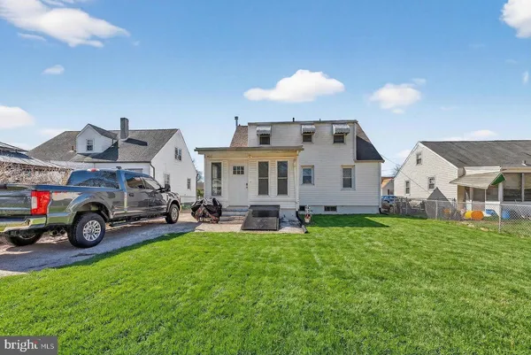 a view of a house with a yard and sitting area