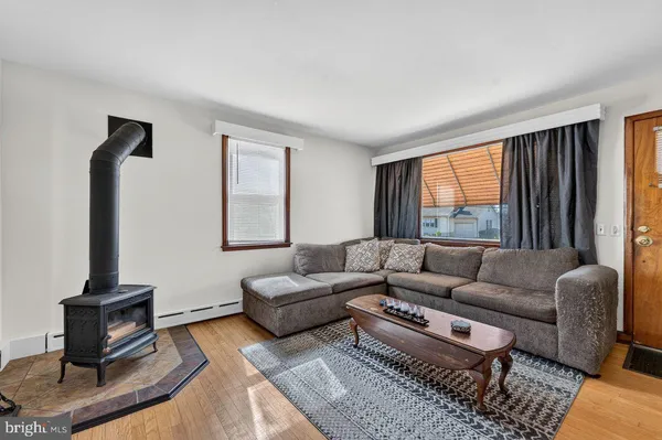 a living room with furniture a rug and a window