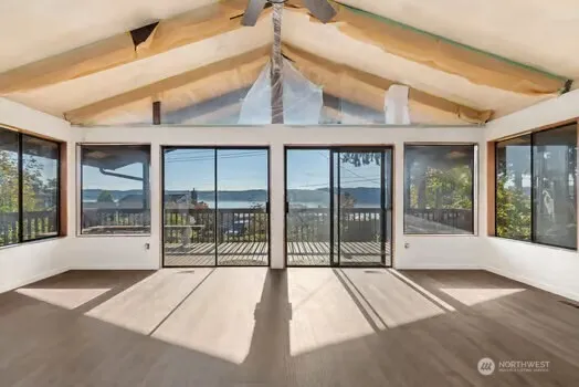 a view of a room with wooden floor and windows