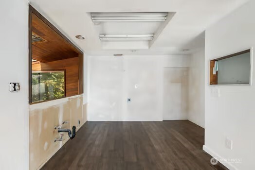 7150 Northeast North Shore Road Belfair, WA 98528 - Photo 18 of 32 a view of an empty room with wooden floor and a window