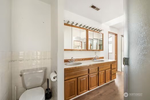 7150 Northeast North Shore Road Belfair, WA 98528 - Photo 24 of 32 a bathroom with a toilet a sink and a mirror