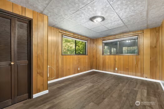 7150 Northeast North Shore Road Belfair, WA 98528 - Photo 28 of 32 an empty room with wooden floor and windows