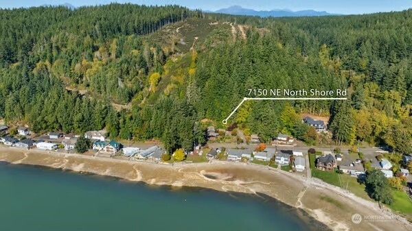 7150 Northeast North Shore Road Belfair, WA 98528 - Photo 3 of 32 a view of a houses with a yard