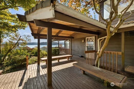 7150 Northeast North Shore Road Belfair, WA 98528 - Photo 6 of 32 a view of balcony with wooden floor and bench