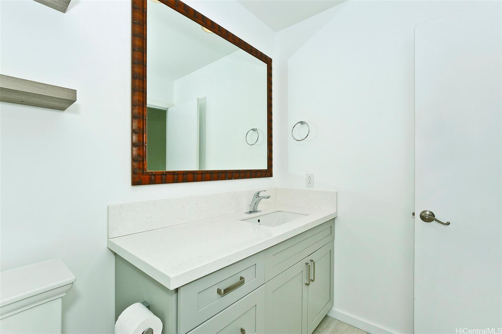 387 Kaelepulu Drive, Unit 1305 Kailua, HI 96734 - Photo 14 of 22 a bathroom with a sink vanity and a mirror