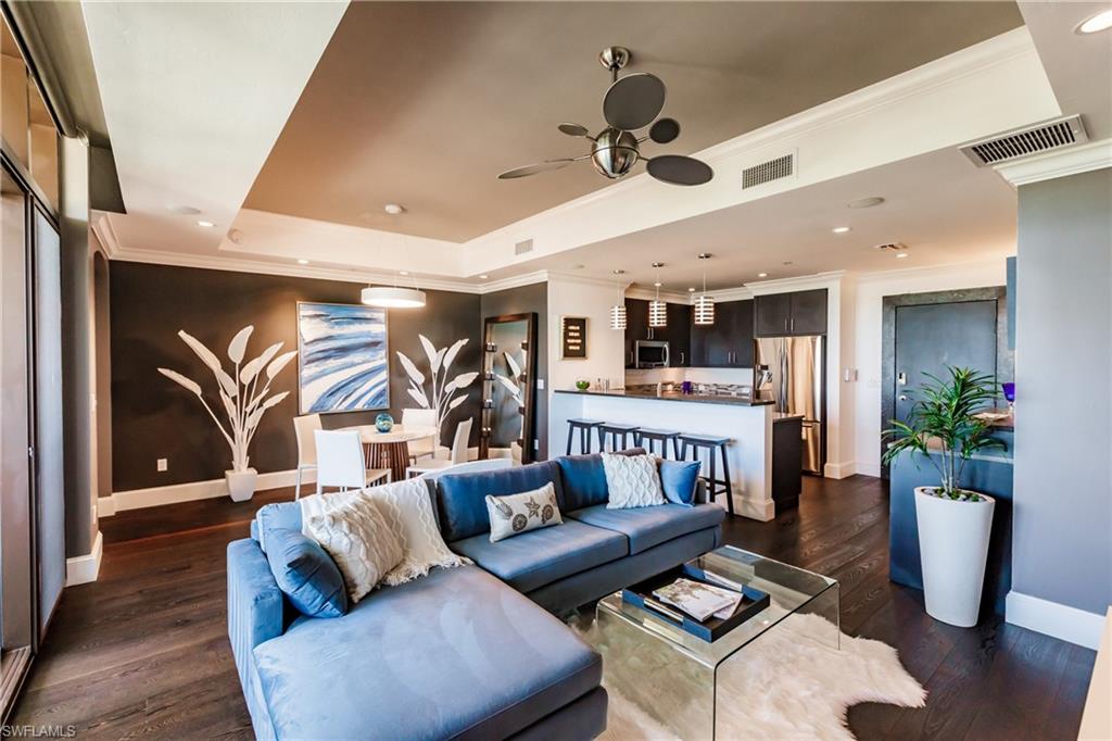 9123 Strada Place, Unit 7509 Naples, FL 34108 - Photo 1 of 48 a living room with furniture and a wooden floor