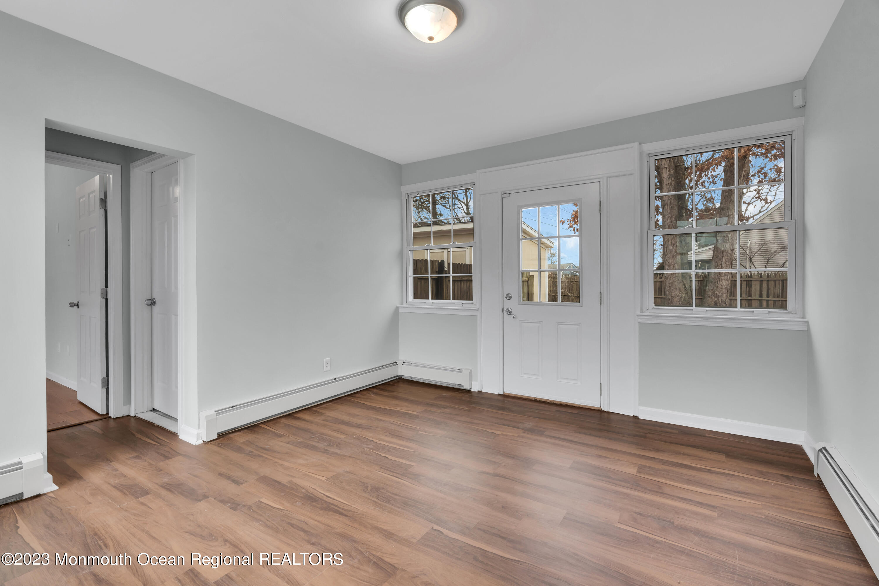 1007 Beaver Dam Road Point Pleasant, NJ 08742 - Photo 24 of 45 a view of an empty room with wooden floor and a window