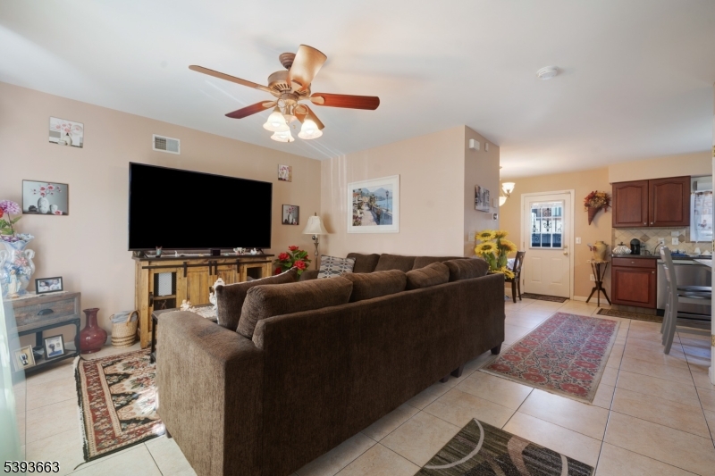 13 Valsumo Lane Newark, NJ 07105 - Photo 3 of 31 a living room with furniture and a flat screen tv