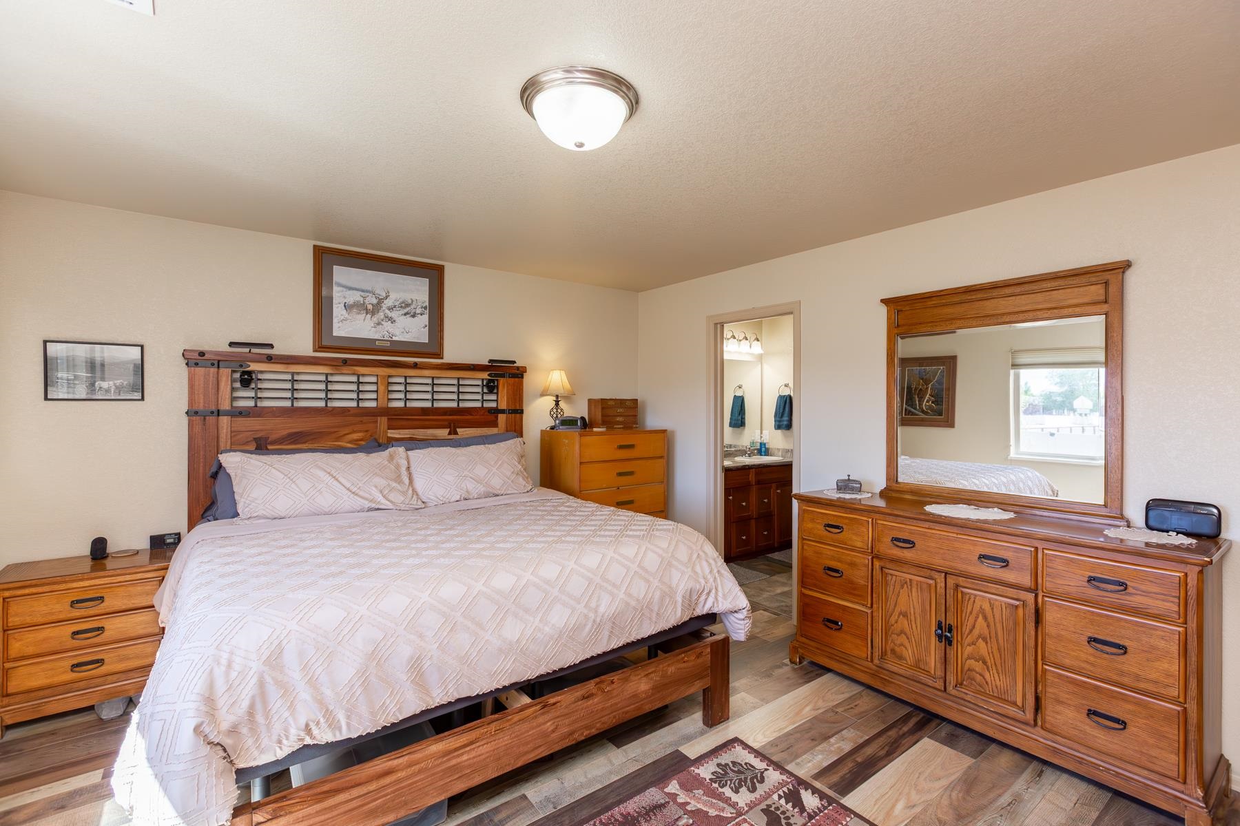 103 Red Rocks Street Fruita, CO 81521 - Photo 34 of 39 a bedroom with a bed and a dresser