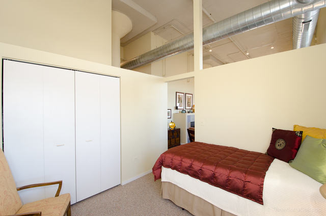 1524 South Sangamon Street, Unit 717S Chicago, IL 60608 - Photo 13 of 14 a bedroom with a bed and a window