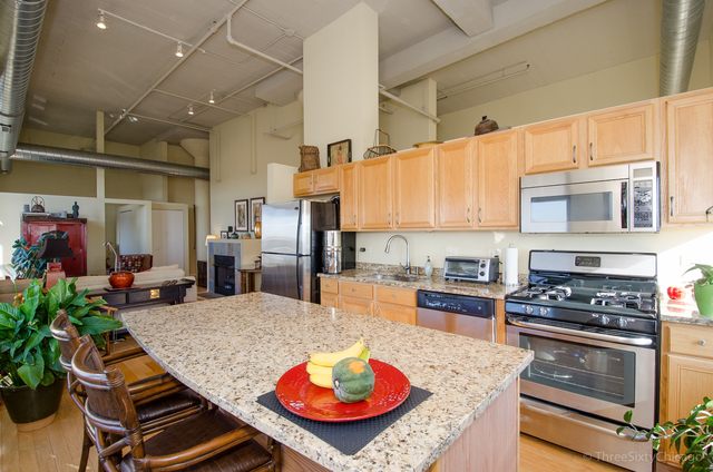 1524 South Sangamon Street, Unit 717S Chicago, IL 60608 - Photo 4 of 14 a kitchen with sink stove and outdoor view