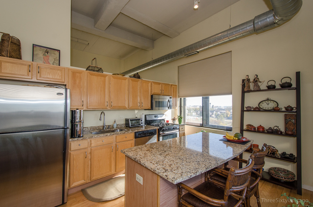 1524 South Sangamon Street, Unit 717S Chicago, IL 60608 - Photo 5 of 14 a kitchen with lots of counter top space and appliances
