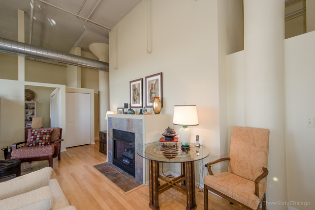 1524 South Sangamon Street, Unit 717S Chicago, IL 60608 - Photo 7 of 14 a living room with furniture and a table