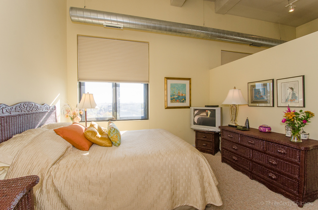 1524 South Sangamon Street, Unit 717S Chicago, IL 60608 - Photo 9 of 14 a bedroom with a bed and window