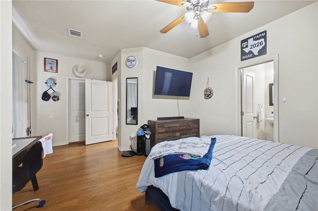 4400 Milam Street Bryan, TX 77801 - Photo 14 of 25 a bedroom with a bed and a flat screen tv