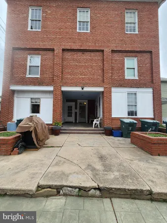 a view of a brick house with many windows