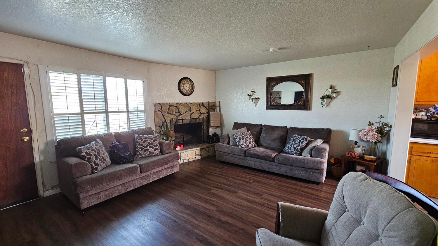 1526 8th Street Firebaugh, CA 93622 - Photo 14 of 57 a living room with furniture and a fireplace