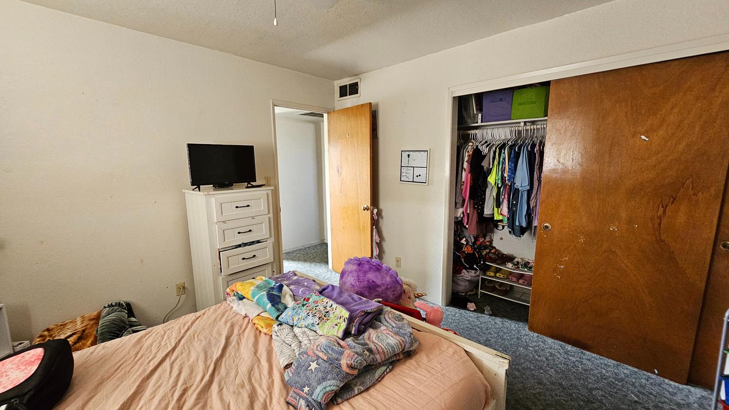 1526 8th Street Firebaugh, CA 93622 - Photo 24 of 57 a bedroom with a bed and flat screen tv