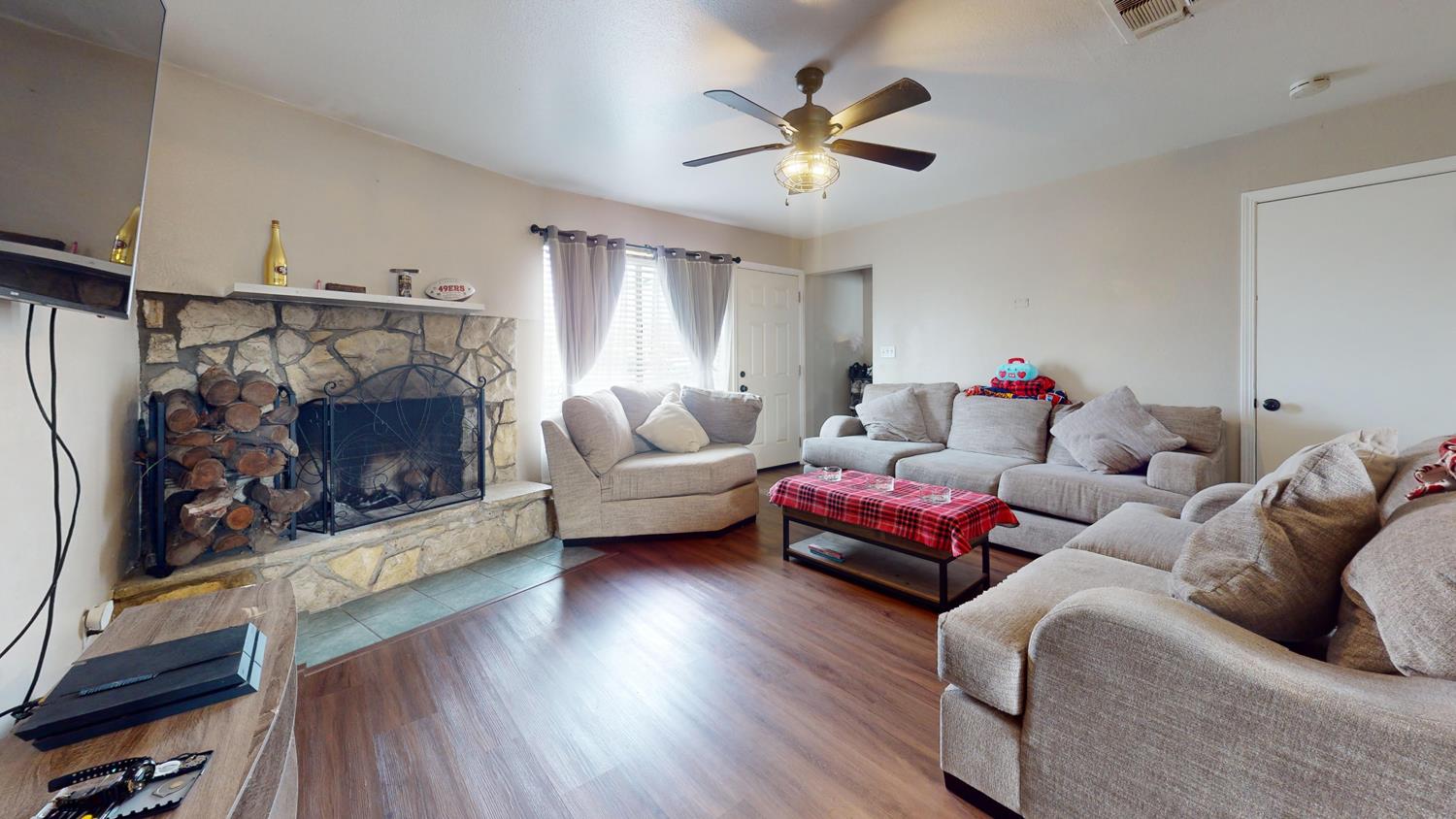 1526 8th Street Firebaugh, CA 93622 - Photo 28 of 57 a living room with furniture and a fireplace