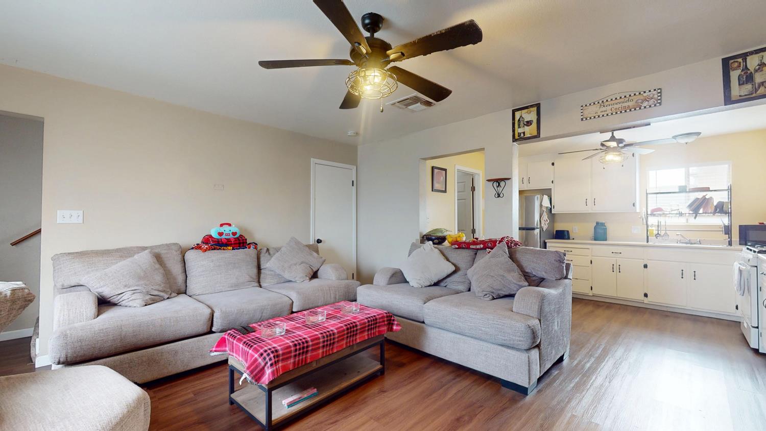 1526 8th Street Firebaugh, CA 93622 - Photo 30 of 57 a living room with furniture and a wooden floor