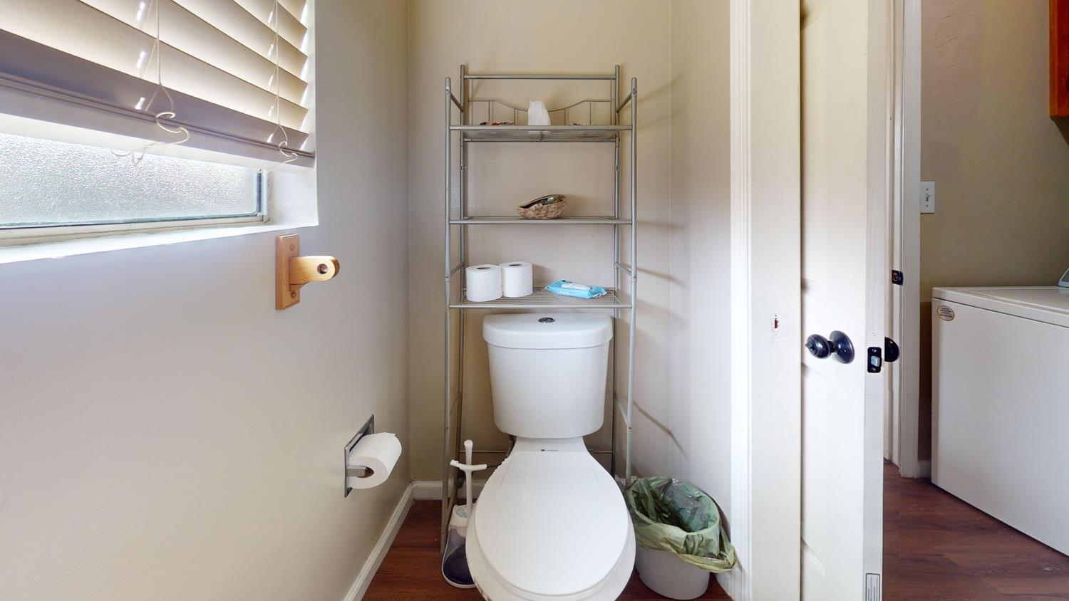 1526 8th Street Firebaugh, CA 93622 - Photo 41 of 57 a white toilet sitting next to a bathroom sink