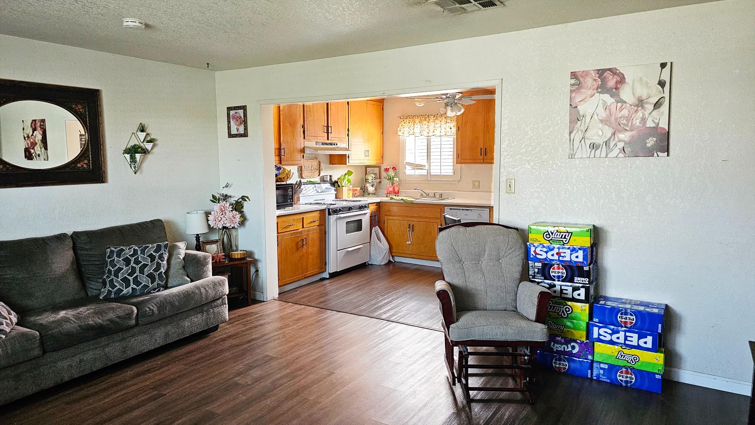 1526 8th Street Firebaugh, CA 93622 - Photo 5 of 57 a living room with furniture and a wooden floor