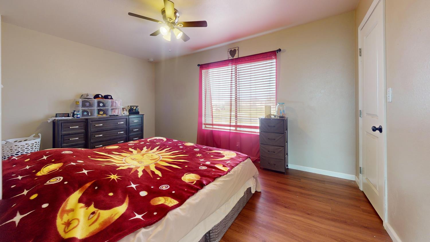 1526 8th Street Firebaugh, CA 93622 - Photo 55 of 57 a bedroom with a bed and dresser with mirror