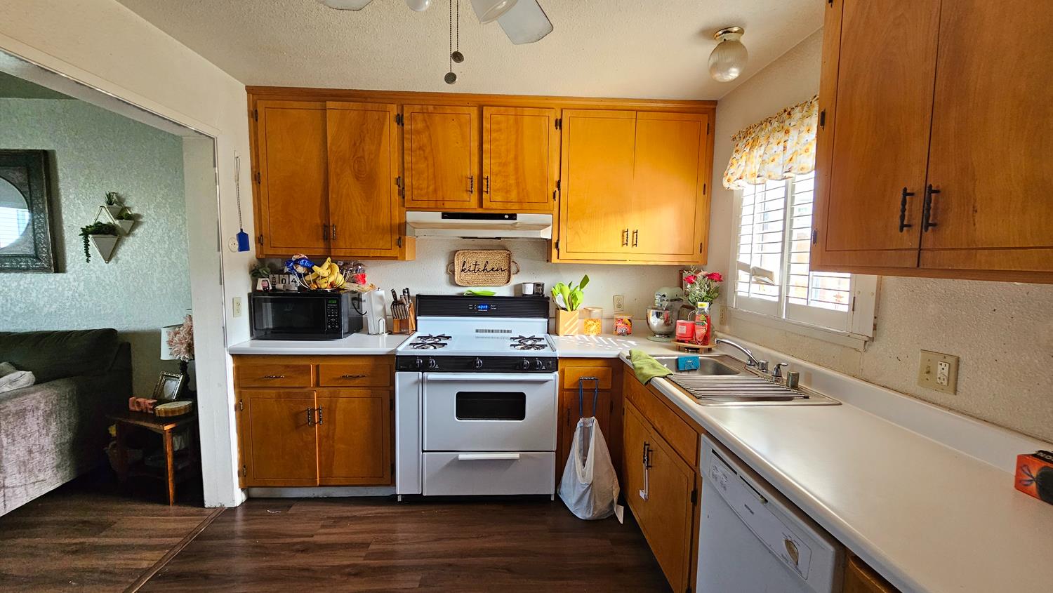 1526 8th Street Firebaugh, CA 93622 - Photo 8 of 57 a kitchen with a sink a stove and cabinets