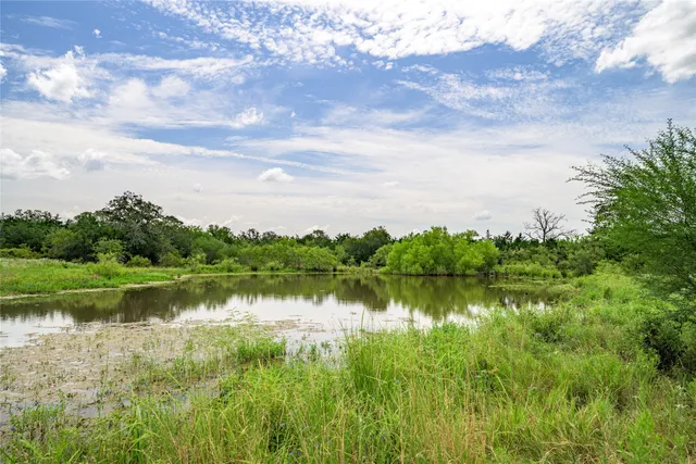 a view of a lake with houses in the back