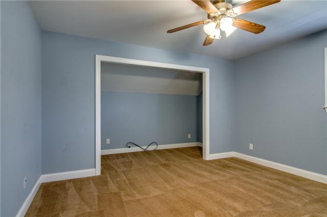 1949 Dillon Road Milton, TN 37118 - Photo 16 of 20 an empty room with windows and chandelier fan