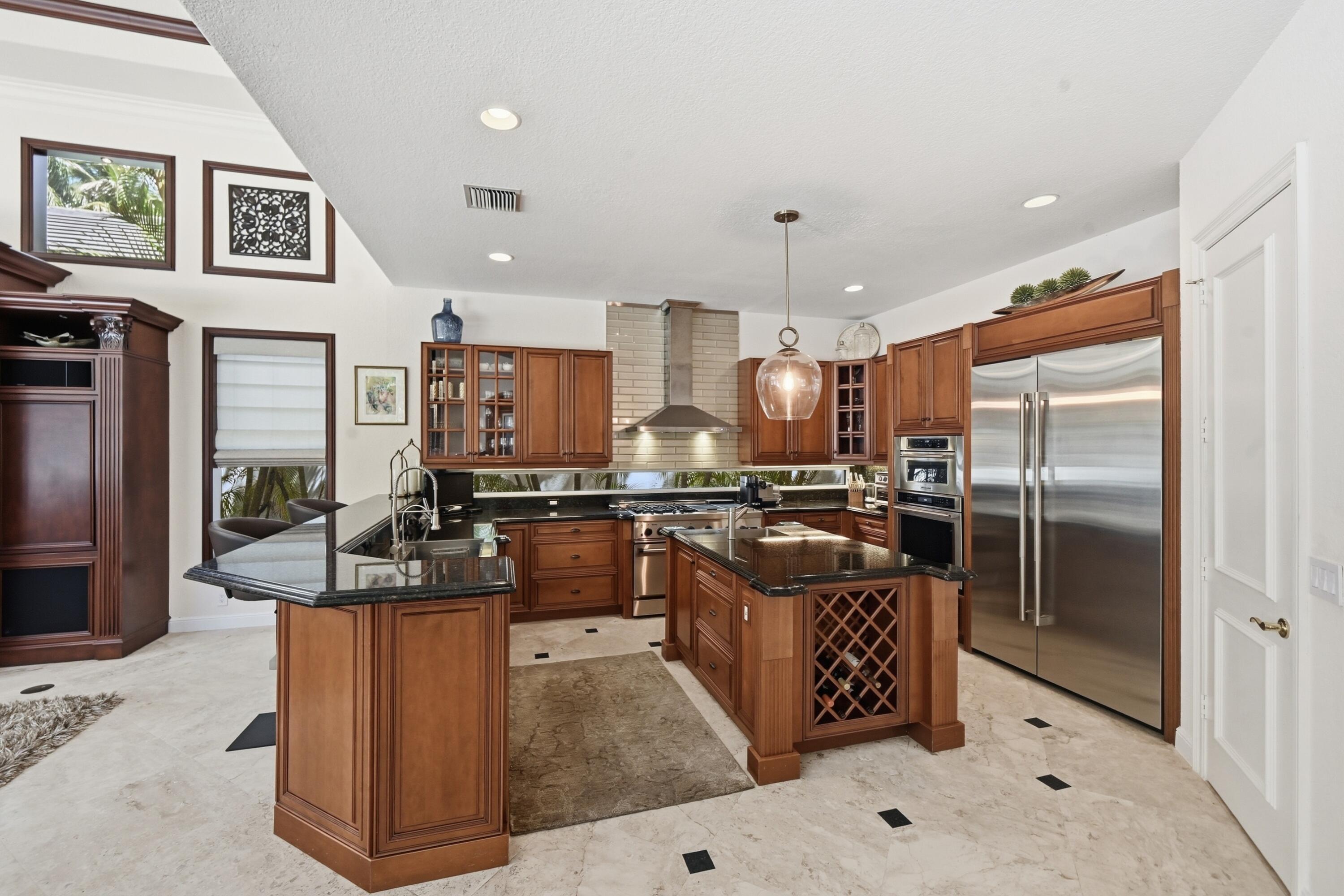 2425 Northwest 49th Lane Boca Raton, FL 33431 - Photo 16 of 46 a kitchen with stainless steel appliances granite countertop a refrigerator a stove and a sink