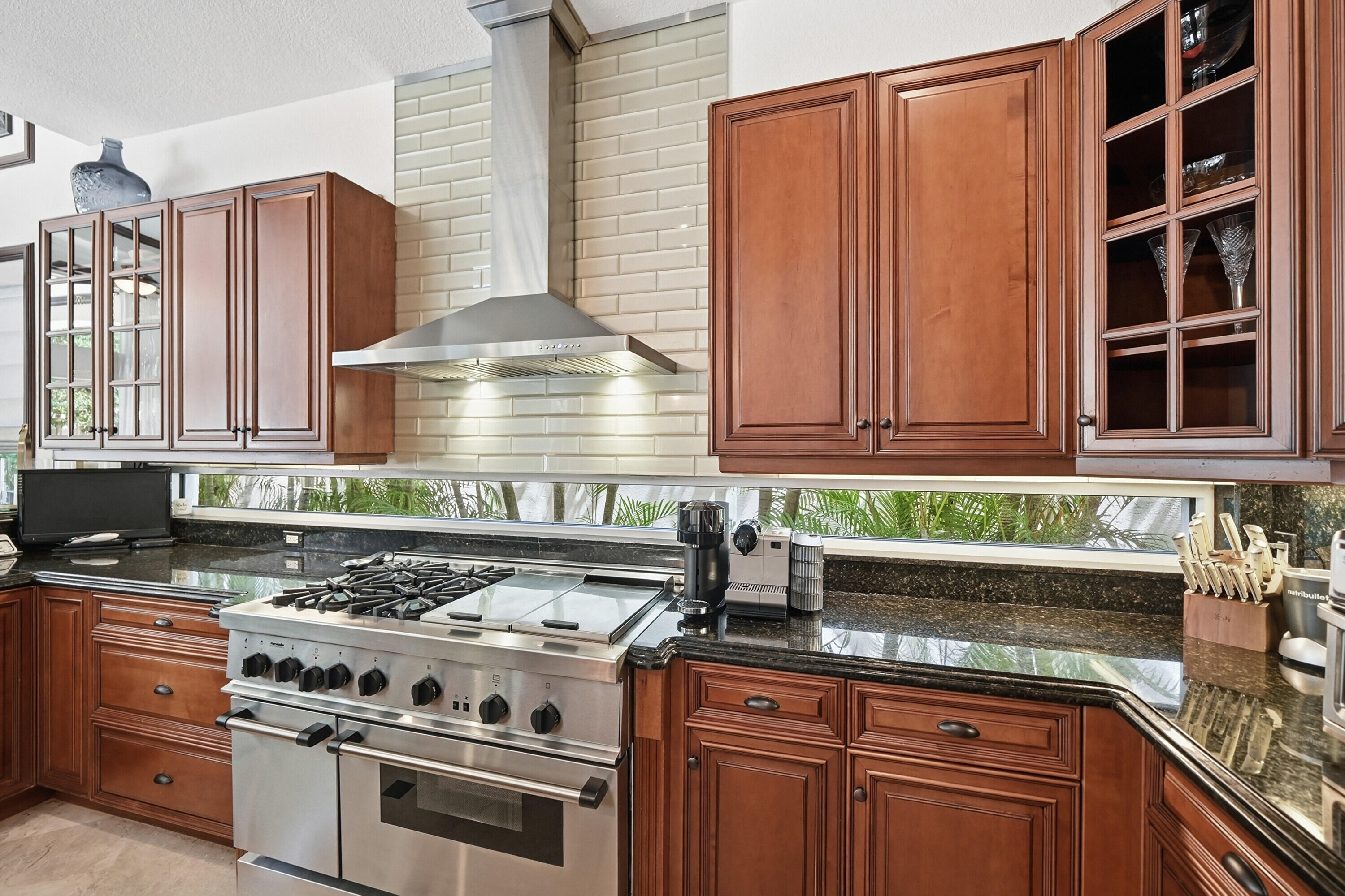 2425 Northwest 49th Lane Boca Raton, FL 33431 - Photo 18 of 46 a kitchen with granite countertop a stove and a sink