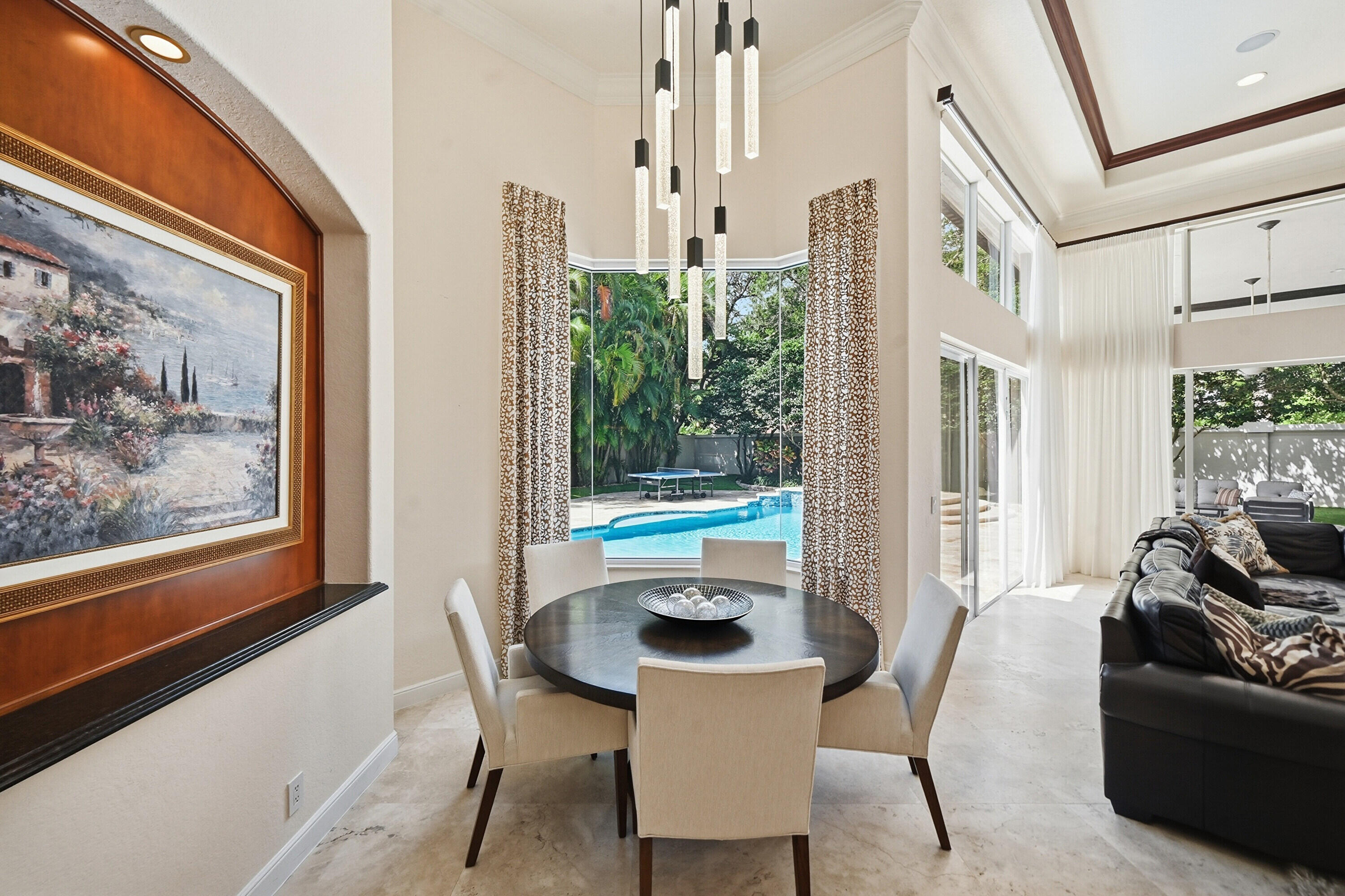 2425 Northwest 49th Lane Boca Raton, FL 33431 - Photo 20 of 46 a dining room with furniture and a floor to ceiling window