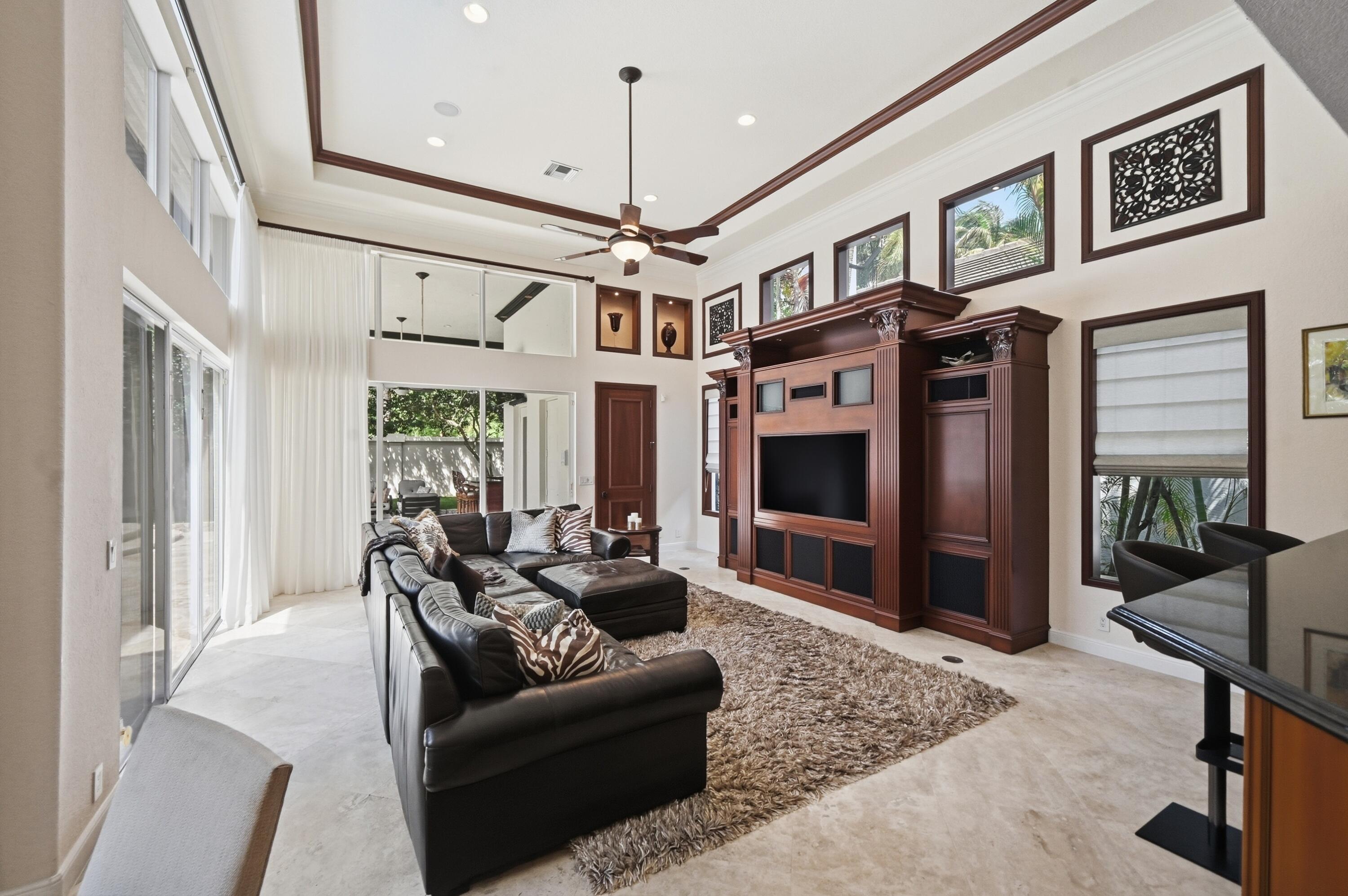 2425 Northwest 49th Lane Boca Raton, FL 33431 - Photo 21 of 46 a living room with furniture a ceiling fan and a window